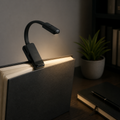Black clip-on reading light on a study desk