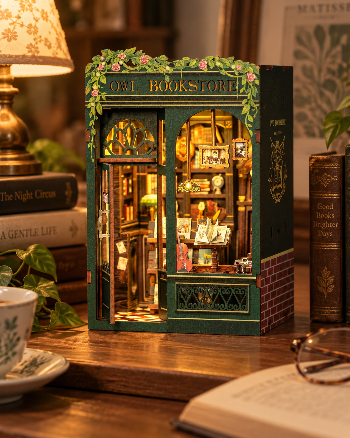 Owl Bookstore finished miniature book nook glowing in a warm home setting