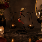 Sculptural Figure Candle Holder with lit tealights on a warm side table