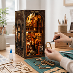 DIY Vintage Tailor Shop Book Nook on a craft table with assembly parts and instructions